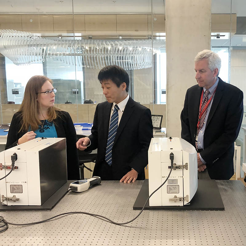 Dr. Martha Wang (left) and Dr. Bill Bentley (right) meet with an industry representative (center) in the Fischell Institute labs